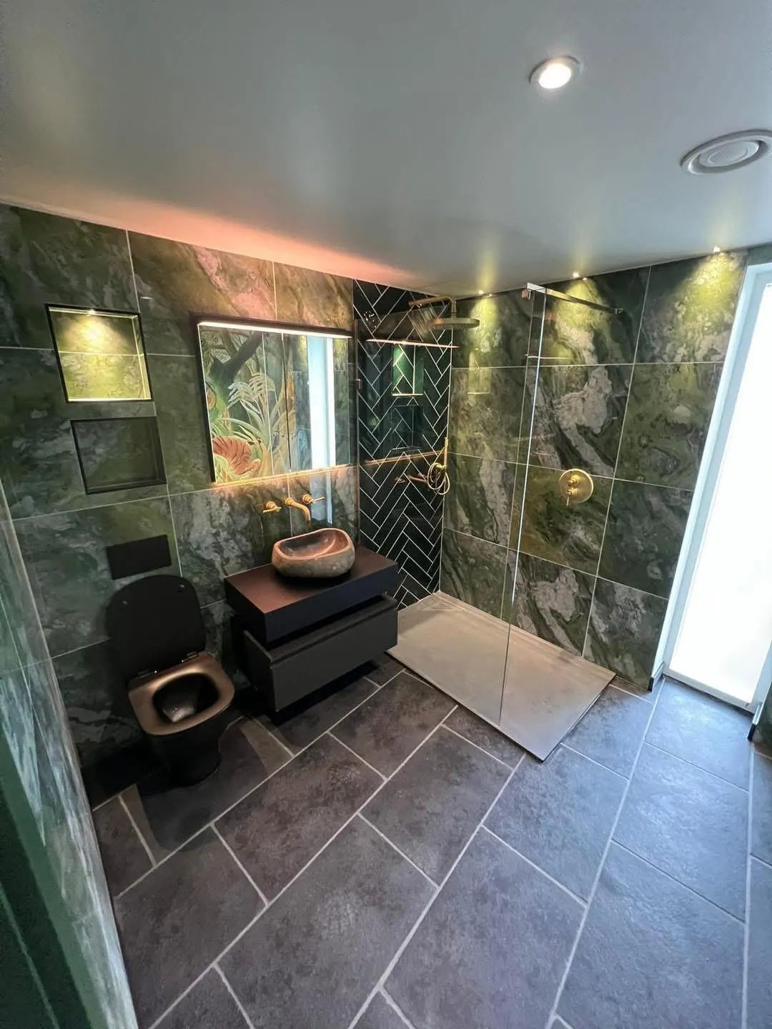 Green-tiled wet room with downlights